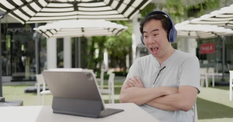 Asian middle aged man wearing glasses, headphone to video call Stock Footage 160141030