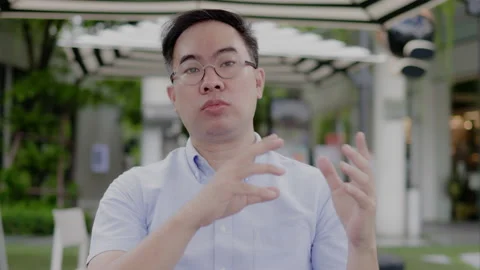 Asian middle aged man wearing glasses, headphone to video call with laptop Stock Footage 161723811