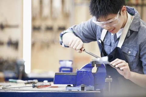 Asian, middle school student in machine shop class Stock Photos