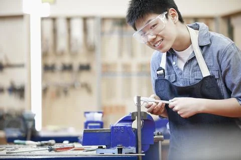 Asian, middle school student in machine shop class Stock Photos