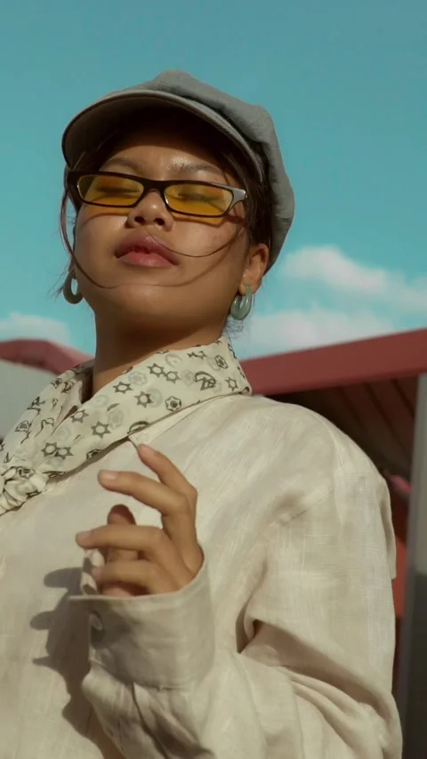 Asian model with sunglasses and hat fashionable clothing posing fashion style Stock Footage 297701131