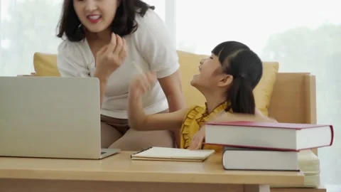 Asian mom teaching kid learning online at home Stock Footage 140425627