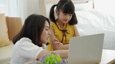 Asian mom teaching kid learning online at home Stock Footage 140425649