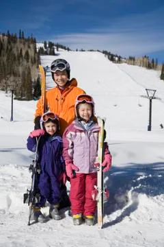 Asian mother and daughters in ski gear Stock Photos