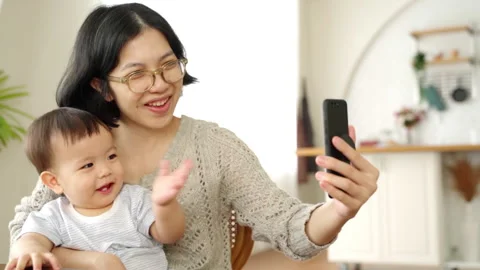 Asian mother and son using smartphone Stock Footage 200091967