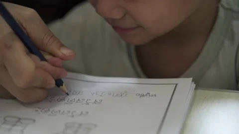 Asian mother help her boy about 4 years old writing his Thai name Stock Footage 133124664