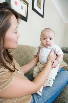 Asian mother holding baby Stock Photos