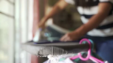 Asian mother laundry and using steam ironing Stock Footage 137012373