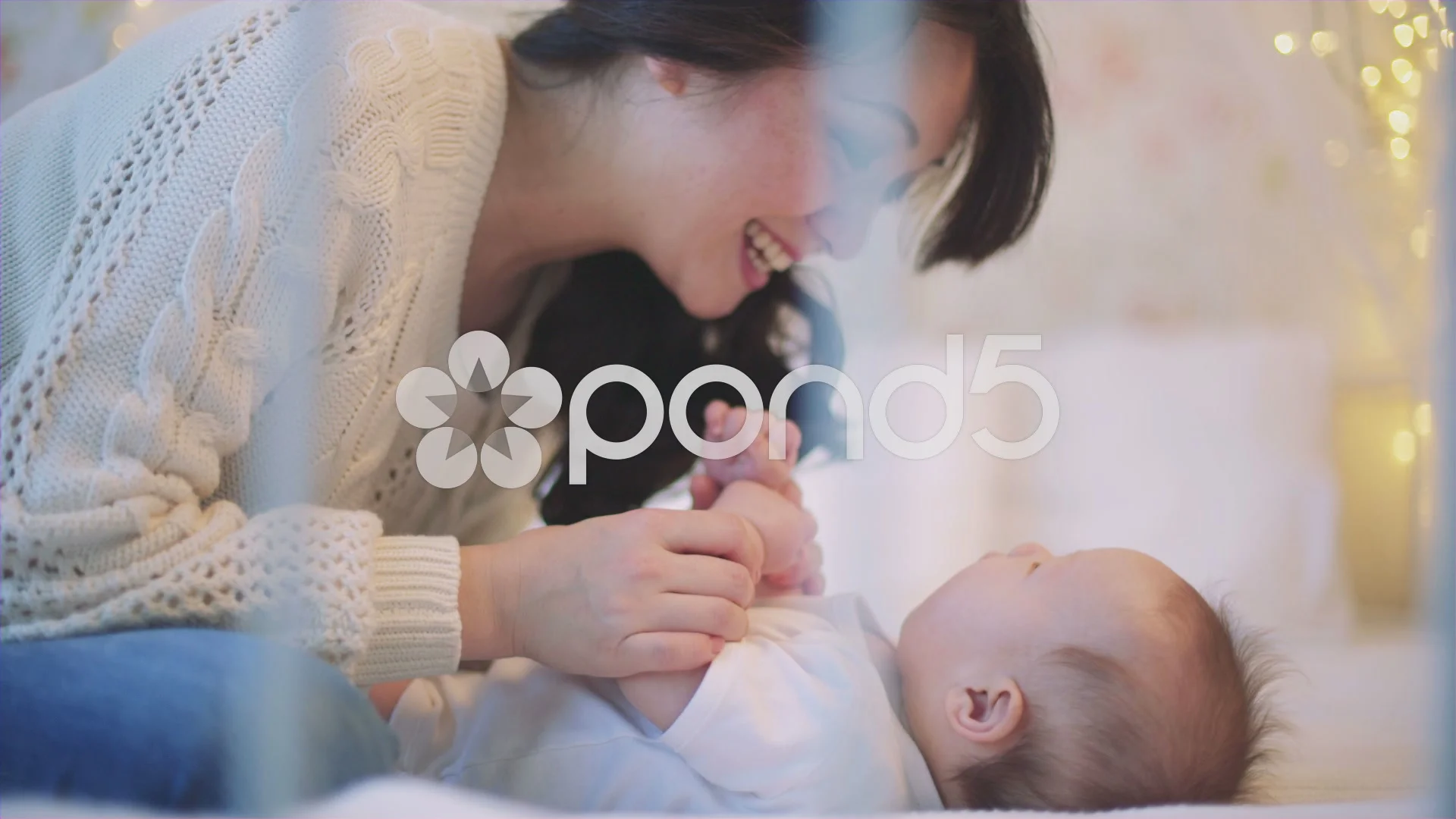 Asian Mother playing with newborn baby