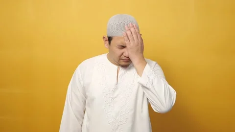Asian muslim man looking at camera with sad and regret expression, disappoint Stock Footage 148260641