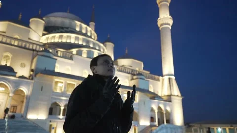 An Asian Muslim man pose in front of the Kocatepe mosque in the evening Stock Footage 185276331