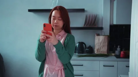 Asian nice-looking young casual woman with smartphone using social media app Stock Footage 131666897