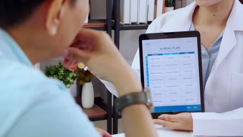 Asian nutritionist using tablet to explaining personalized meal plan with A.. Stock Footage 313068707