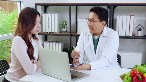 Asian nutritionist using tablet to explaining personalized meal plan with A.. Stock Footage 332321115