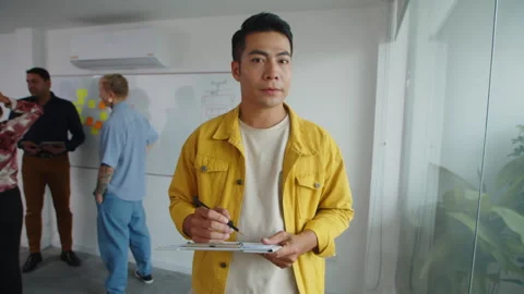 Asian Office Worker Smiling at Camera Stock Footage 263033908