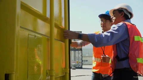 Asian old foreman talking on the walkie-talkie open and checking in  Contai.. Stock Footage 242307934
