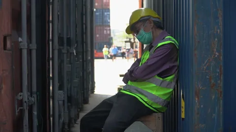 Asian old man container worker    sleep at work in outdoors warehouse . sen.. Stock Footage 248360050