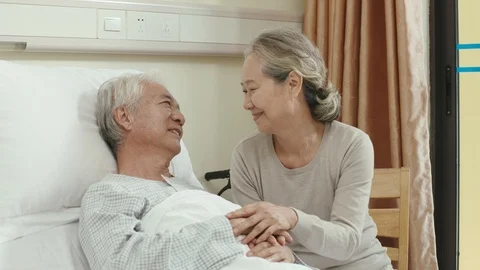 Asian old man getting a visit from loving wife Stock Footage 124123660
