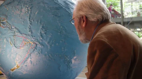Asian old man rotating the globe Stock Footage 36149903
