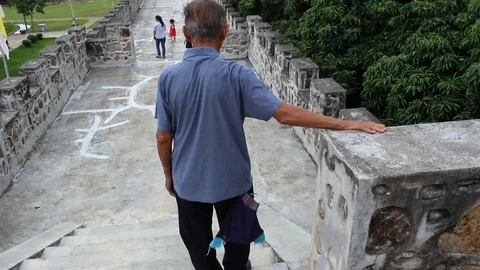 Asian old man walking down the stairs at Santichon Chinese Village, Thailand. Stock Footage 114543052