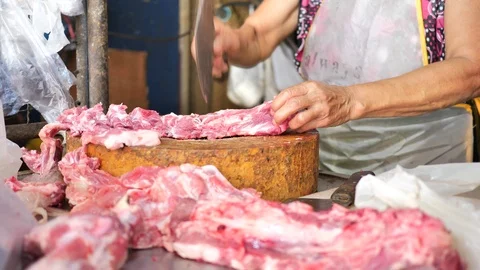 Asian Old woman butcher chop the pork rack Stock Footage