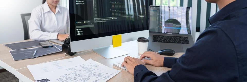 Asian Outsource Software engineer Developer Team Working Code to find solutio Stock Photos