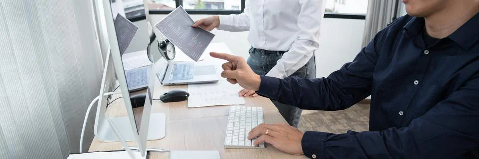 Asian Outsource Software engineer Developer Team Working Code to find solutio Stock Photos