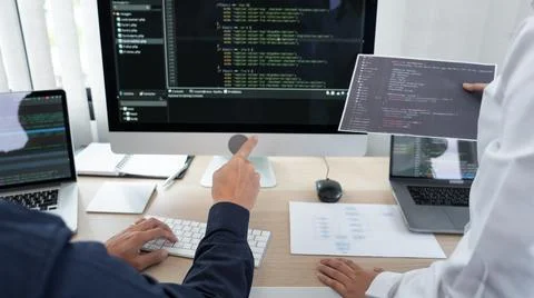 Asian Outsource Software engineer Developer Team Working Code to find solutio Stock Photos