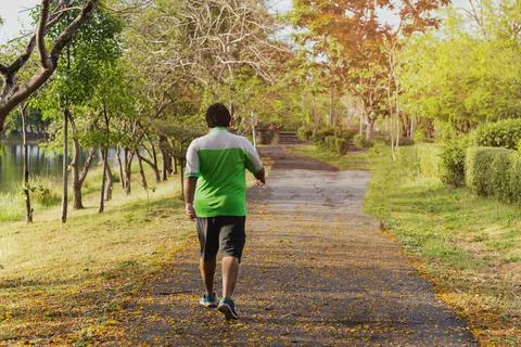 Asian oversize man walking exercise in the park. Fotos de archivo