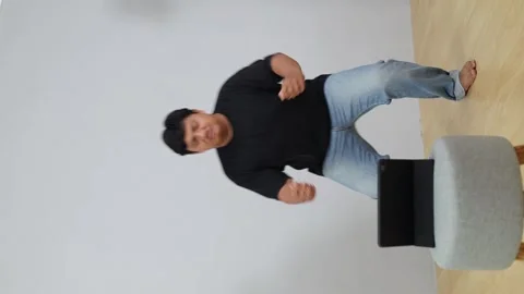 Asian Overweight man does online home fitness workout, following training Stock Footage 342475521