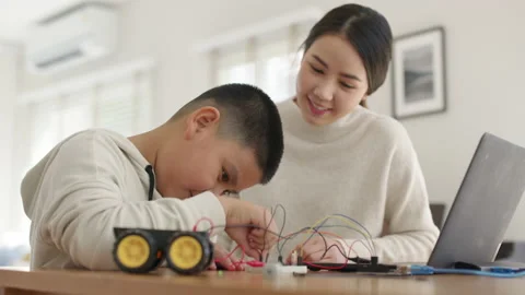 Asian parent teach kid learn coding toy stem car at home. Stock Footage 152604271