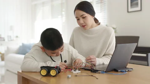 Asian parent teach kid learn coding toy stem car at home. Video stock 152604380