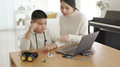 Asian parent teach kid learn coding toy stem car at home. Video stock 152605167