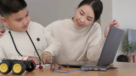 Asian parent teach kid learn coding toy stem car at home. Video stock 152605401