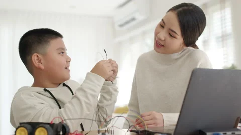 Asian parent teach kid learn coding toy stem car at home. Video stock 152605652