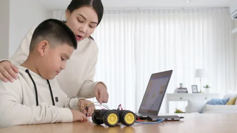 Asian parent teach kid learn coding toy stem car at home. Video stock 152605867