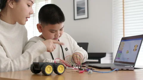Asian parent teach kid learn coding toy stem car at home. Video stock 152606270