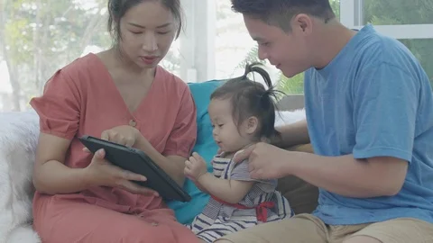 Asian parents are using a tablet computer. Video stock 124198652