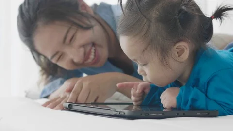 Asian parents are using a tablet computer. Video stock 124204746