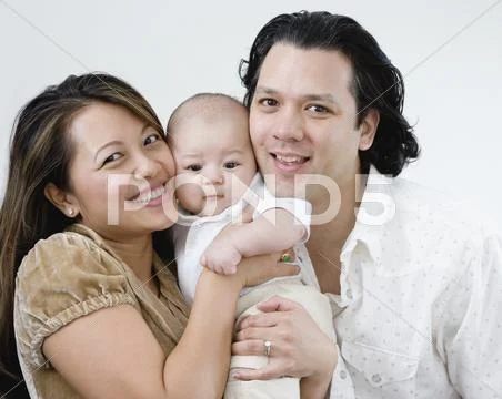 Asian Parents Hugging Baby