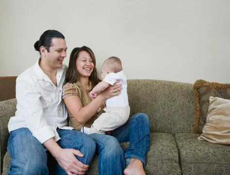 Asian parents smiling at baby Stock Photos