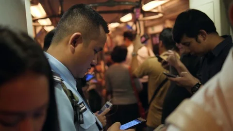 Asian People Using Smart Phones and Gadgets Inside BTS Subway Train Wagon. 4K Stock Footage
