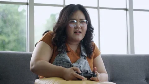 Asian plus size woman with joystick playing computer online game Stock-Footage 137002753