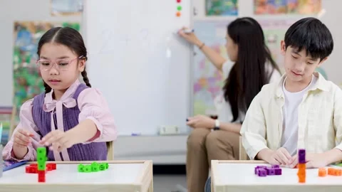 Asian Primary School Students Learning Math With Colorful Counting Cubes Stock Footage 326747933