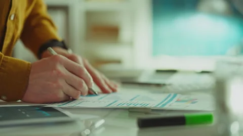 An Asian professional employee works with data, looks for the necessary opti Stock Footage 285188596