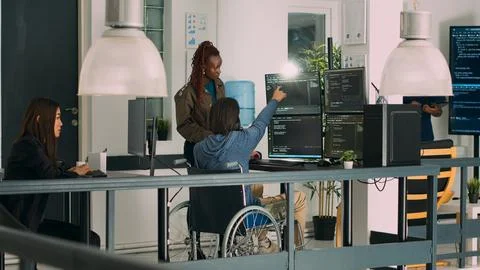 Asian programer with chronic impairment working on software code Foto stock