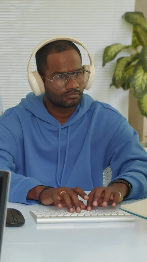 Asian Programmer in Headphones Coding on Computer Stock Footage 279131946