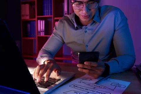 Asian Programmer Working on Computer App 写真素材