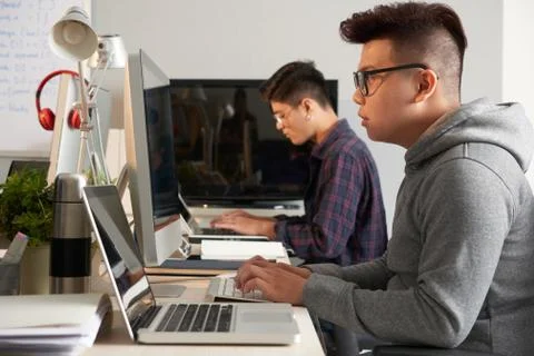 Asian Programmers Wrapped up in Work 스톡 사진