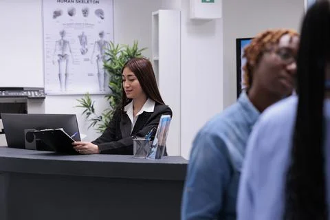 Asian receptionist checking report papers Stock Photos